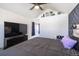 Comfortable main bedroom with a vaulted ceiling and geometric accent wall for added design interest at 5976 S Jellison St # E, Littleton, CO 80123