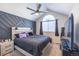 Comfortable main bedroom with a vaulted ceiling and geometric accent wall for added design interest at 5976 S Jellison St # E, Littleton, CO 80123