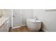 Modern bathroom with standalone tub and sleek white fixtures, promoting a spa-like experience at 13695 Emerald Lake St, Parker, CO 80138