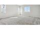 Bright, empty bedroom with neutral carpet and large windows offering plenty of natural light at 13695 Emerald Lake St, Parker, CO 80138