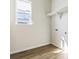 Functional laundry room with hookups, shelving, and wood-look flooring for added convenience at 13695 Emerald Lake St, Parker, CO 80138