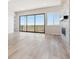 Bright living room featuring a stone fireplace, large windows, and sliding doors at 13695 Emerald Lake St, Parker, CO 80138