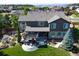 Aerial view of the home showcasing the backyard with a patio, greenhouse, and landscaping at 7408 Sodalite Way, Castle Rock, CO 80108
