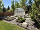 Lush backyard featuring a greenhouse, garden beds, and well-maintained lawn at 7408 Sodalite Way, Castle Rock, CO 80108
