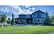 Expansive backyard featuring a covered patio, lush lawn, and beautiful landscaping, perfect for outdoor living at 7408 Sodalite Way, Castle Rock, CO 80108