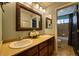 Stylish bathroom vanity with double sinks, granite countertop, and decorative mirror at 7408 Sodalite Way, Castle Rock, CO 80108