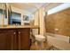 Well-lit bathroom with a vanity, toilet, and combined shower and bathtub at 7408 Sodalite Way, Castle Rock, CO 80108