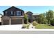 Beautiful two story home showcasing a well-manicured yard and attached two car garage at 7408 Sodalite Way, Castle Rock, CO 80108