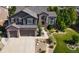 Stunning two-story home with a three-car garage, stone accents, and manicured landscaping at 7408 Sodalite Way, Castle Rock, CO 80108