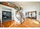 Elegant foyer showcasing curved staircase, hardwood floors, and views into dining and living spaces at 7408 Sodalite Way, Castle Rock, CO 80108