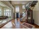 Bright, welcoming foyer with high ceilings, hardwood floors, and a grand staircase at 7408 Sodalite Way, Castle Rock, CO 80108