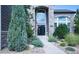 Inviting home exterior featuring stone accents, a statement entry door, and lush landscaping at 7408 Sodalite Way, Castle Rock, CO 80108