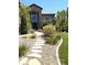 Beautiful home exterior with stone accents, manicured landscaping, and inviting walkway at 7408 Sodalite Way, Castle Rock, CO 80108