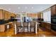 Well-lit kitchen featuring hardwood floors, a center island, and ample cabinet space at 7408 Sodalite Way, Castle Rock, CO 80108