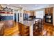 Spacious kitchen with an island, granite countertops, stainless steel appliances, and hardwood floors at 7408 Sodalite Way, Castle Rock, CO 80108
