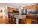 Spacious kitchen with center island, wood cabinetry, and stainless steel appliances at 7408 Sodalite Way, Castle Rock, CO 80108