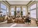 Bright living room with hardwood floors, fireplace, and large windows at 7408 Sodalite Way, Castle Rock, CO 80108