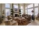 Cozy living room with fireplace, large windows, and plush seating at 7408 Sodalite Way, Castle Rock, CO 80108