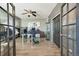 Office with glass desk, custom airplane themed wall and ceiling fan at 7408 Sodalite Way, Castle Rock, CO 80108