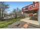 Spacious backyard with a covered deck, mature trees, and a landscaped lawn at 3823 S Uravan St, Aurora, CO 80013