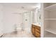 Bathroom featuring a glass-enclosed shower, vanity, and adjacent shelving unit at 3823 S Uravan St, Aurora, CO 80013