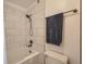Bright bathroom features a tub with tile surround and updated fixtures at 3823 S Uravan St, Aurora, CO 80013