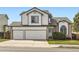 Charming two-story home with a two-car garage, manicured lawn, and beautiful architectural details at 3823 S Uravan St, Aurora, CO 80013