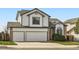 Charming two-story home with a two-car garage, manicured lawn, and beautiful architectural details at 3823 S Uravan St, Aurora, CO 80013