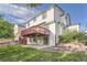 Back of home featuring a spacious upper deck and a lower patio at 3823 S Uravan St, Aurora, CO 80013