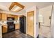 Kitchen with granite counters, oak cabinets, and black appliances at 3823 S Uravan St, Aurora, CO 80013