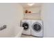 Functional laundry room with modern washer, dryer, and utility sink at 3823 S Uravan St, Aurora, CO 80013