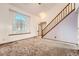 Living room featuring carpet, stairs, and a half moon window at 3823 S Uravan St, Aurora, CO 80013