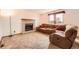 Living room with a brick fireplace and plush brown sofa at 3823 S Uravan St, Aurora, CO 80013