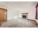 Carpeted living room featuring a brick fireplace and light walls at 3823 S Uravan St, Aurora, CO 80013