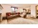 Open-concept living area with a fireplace and view of the kitchen at 3823 S Uravan St, Aurora, CO 80013