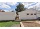 View of the home's exterior with a large tree and garden bed at 4521 E Jewell Ave, Denver, CO 80222
