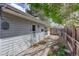 Side view of home and back yard with wooden privacy fence and path at 4521 E Jewell Ave, Denver, CO 80222