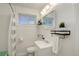 Clean bathroom featuring white vanity, mirror, and black shelving at 4521 E Jewell Ave, Denver, CO 80222
