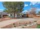 Charming single-story home featuring a large tree, covered parking, and well-maintained landscaping at 4521 E Jewell Ave, Denver, CO 80222