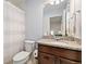 Granite counters accent this full bathroom, complete with a vanity and a shower with a curtain at 7808 W 43Rd Pl, Wheat Ridge, CO 80033