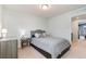 Neutral bedroom with large bed, side table, and carpeted floor at 7808 W 43Rd Pl, Wheat Ridge, CO 80033