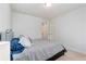 A cozy bedroom featuring neutral walls, carpeted floors, and a comfortable queen-sized bed at 7808 W 43Rd Pl, Wheat Ridge, CO 80033