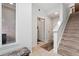 The entryway boasts tiled floors, neutral paint, and a staircase leading to the upper floors at 7808 W 43Rd Pl, Wheat Ridge, CO 80033