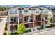 A modern townhome community with brick accents and charming balconies overlooking manicured landscaping at 7808 W 43Rd Pl, Wheat Ridge, CO 80033