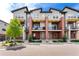 The townhome community showcases modern brick accents, well-placed greenery, and individual balconies at 7808 W 43Rd Pl, Wheat Ridge, CO 80033