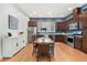 Spacious kitchen with stainless steel appliances, dark wood cabinetry, and an adjacent dining area at 7808 W 43Rd Pl, Wheat Ridge, CO 80033