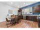 Inviting kitchen with stainless steel appliances, dark wood cabinets, and a dining table next to a window at 7808 W 43Rd Pl, Wheat Ridge, CO 80033