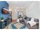 Living room with blue accent wall, sectional couch, and access to balcony at 7808 W 43Rd Pl, Wheat Ridge, CO 80033