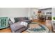Comfortable living room with a sectional sofa, area rug and a view of the kitchen and dining area at 7808 W 43Rd Pl, Wheat Ridge, CO 80033