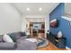 Open living room flowing to kitchen featuring sectional couch, and blue accent wall at 7808 W 43Rd Pl, Wheat Ridge, CO 80033